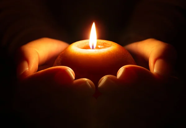 depositphotos_57491911-stock-photo-prayer-candle-in-hands